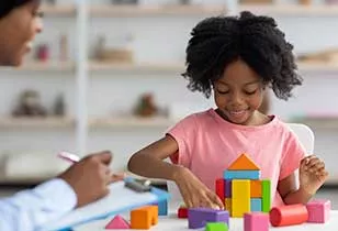 reducing-problem-behavior-coral-gables a therapist developing an IEP for a child to help reduce problem behaviors