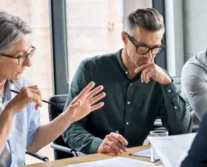 staff discussing a document