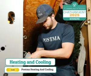 HVAC technician from Postma Heating and Cooling performing furnace maintenance in Chatham-Kent; 2025 CommunityVotes Gold Winner for heating services.
