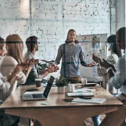 Group of 6 people in a board room.