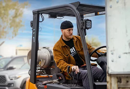 logistics and warehouse worker moving a pallet of products careers in commercial printing