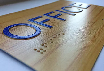 ADA office placard with braille.