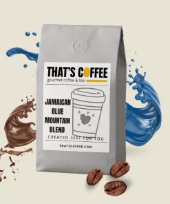 A bag of Jamaican Blue Mountain Blend Coffee with coffee beans and splashes of brown and blue liquid in the background.