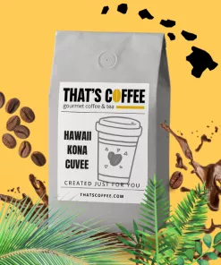 A gray coffee bag labeled "That's Coffee: Handpicked Kona Cuvee Coffee Beans" rests among fresh beans, coffee splashes, and green leaves on a bright yellow background.