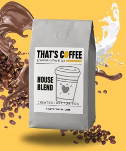 A gray bag of Gourmet House Blend Coffee Beans is shown with coffee beans, a splash of coffee, and a splash of milk against a yellow background.