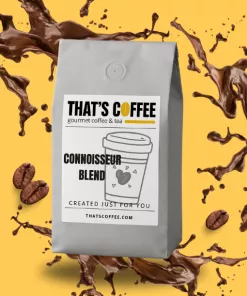 A gray bag of "Connoisseur Blend" coffee from That's Coffee is displayed against a yellow background with splashes of coffee, coffee beans, and hints of their signature coffee blends.