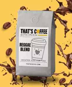 A silver coffee bag labeled “That’s Coffee Reggae Blend” sits against a yellow background, surrounded by brazil coffee beans and dynamic splashes.
