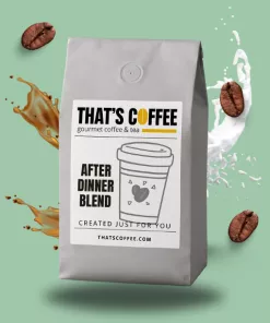 A gray bag of That’s Coffee After Dinner Blend sits upright, surrounded by splashes of coffee, milk, and Medium Roast Coffee Beans, against a light green background.