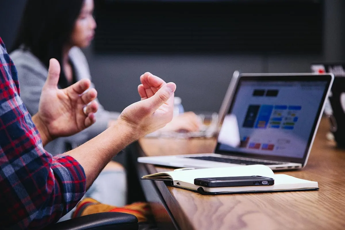 conversation-to-convert-sales Man's hands during a conversation at a conference table