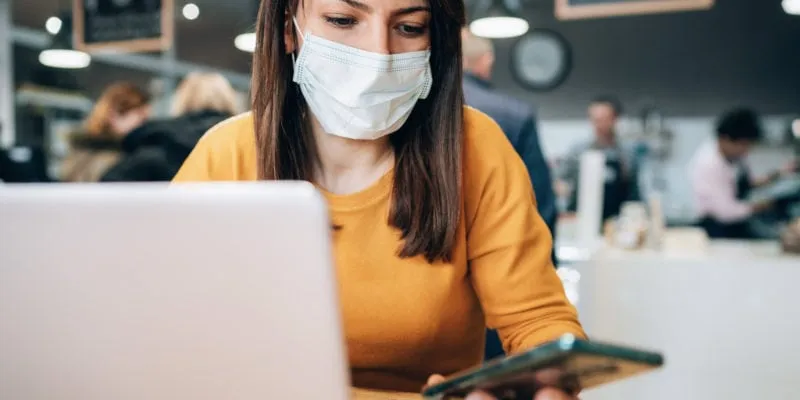Woman with face protective mask calling phone