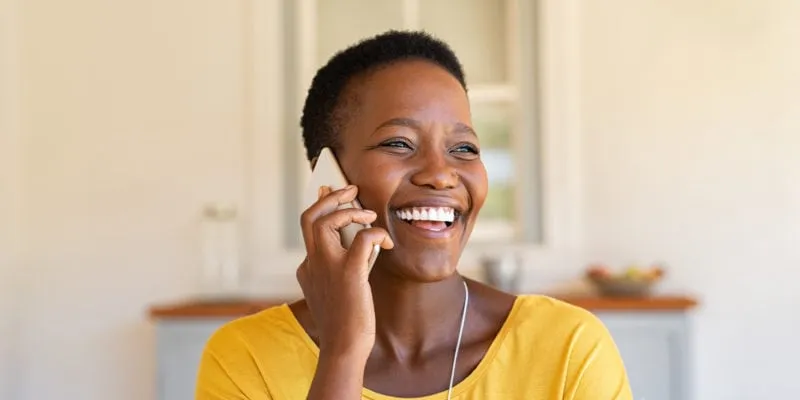 Happy woman engaging in a phone call, showcasing relationship-building strategies over sales calls.