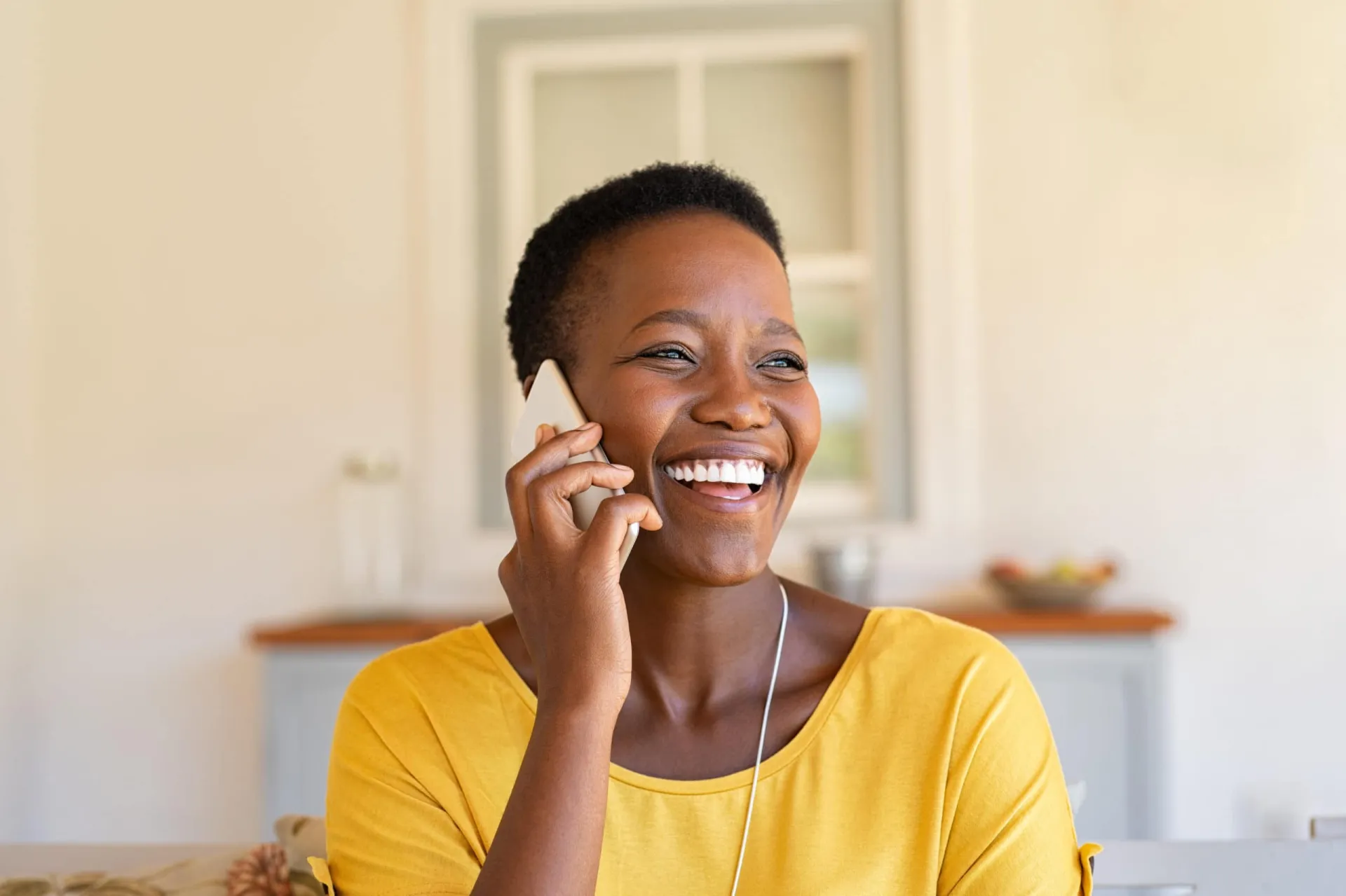 Effective Relationship Building Campaigns for Business Growth Happy woman engaging in a phone call, showcasing relationship-building strategies over sales calls.