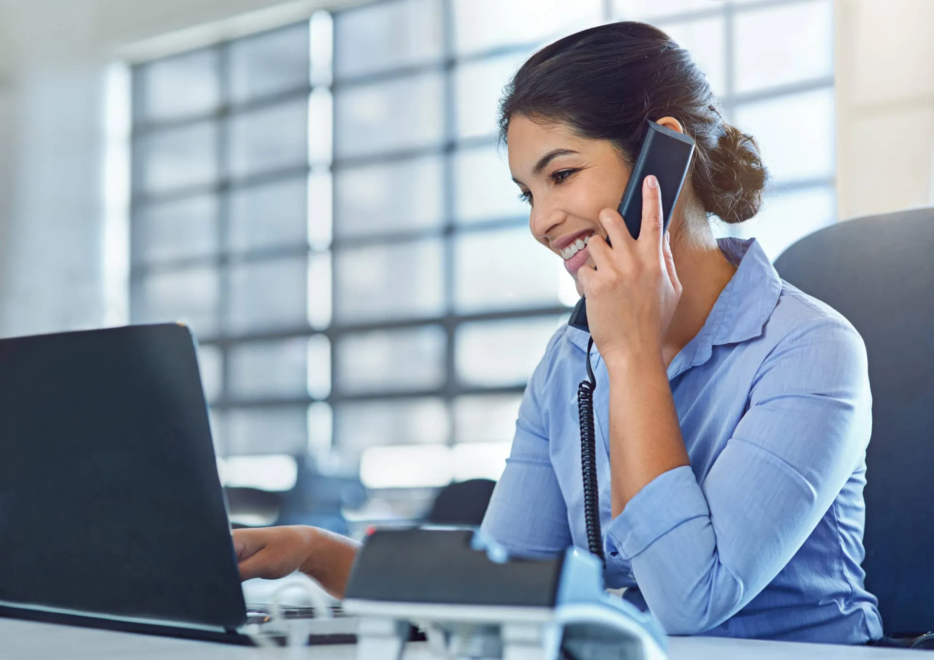 Warm calling for sales engagement Businesswoman making a warm sales call with a headset in an office setting.