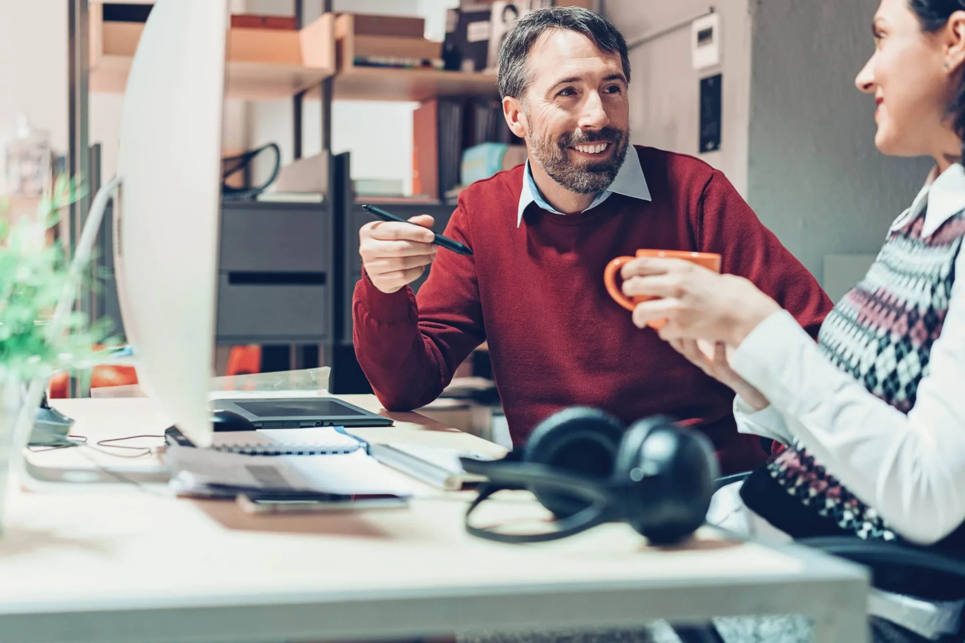Connecting Through Conversation in Sales Two professionals engaging in a friendly conversation during a sales meeting.