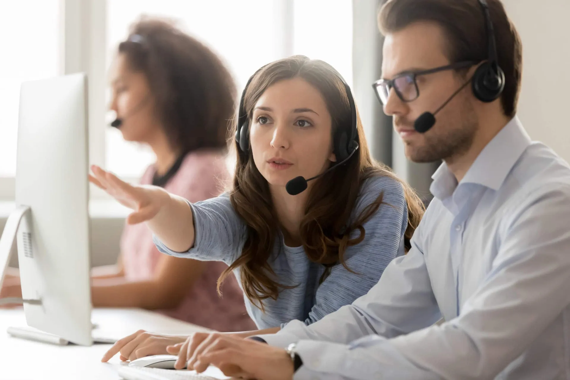Inside Sales Team Supporting Customers for Business Growth Customer support representatives using headsets in a call center environment.