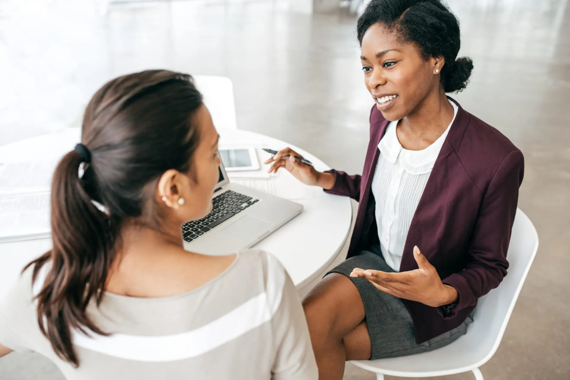Effective Sales Conversation Strategies Businesswoman engaging in a sales discussion with a client in an office setting.