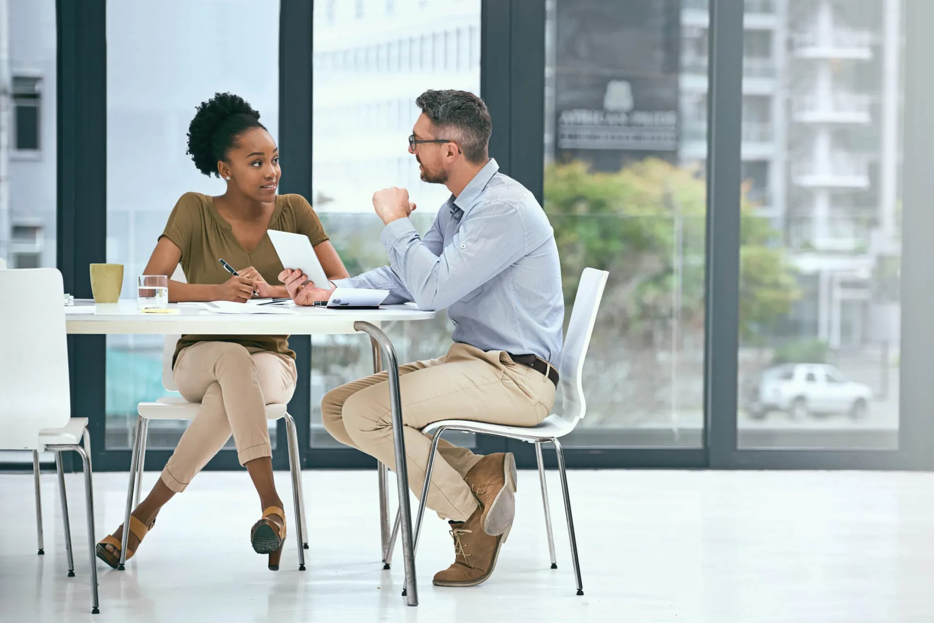 Sales mentoring session for business growth and development. Business professionals engaging in a sales mentoring discussion in a modern office.