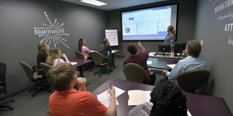 Professional callers participating in a team training session at Volkart May.