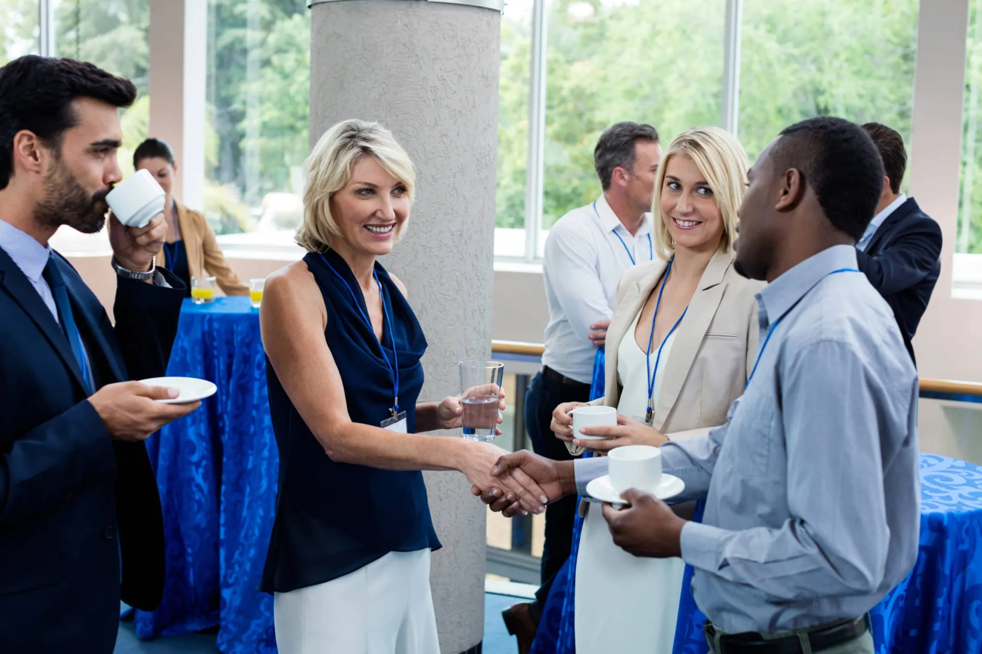 Networking at a professional event for business growth Business professionals exchanging greetings and building connections.