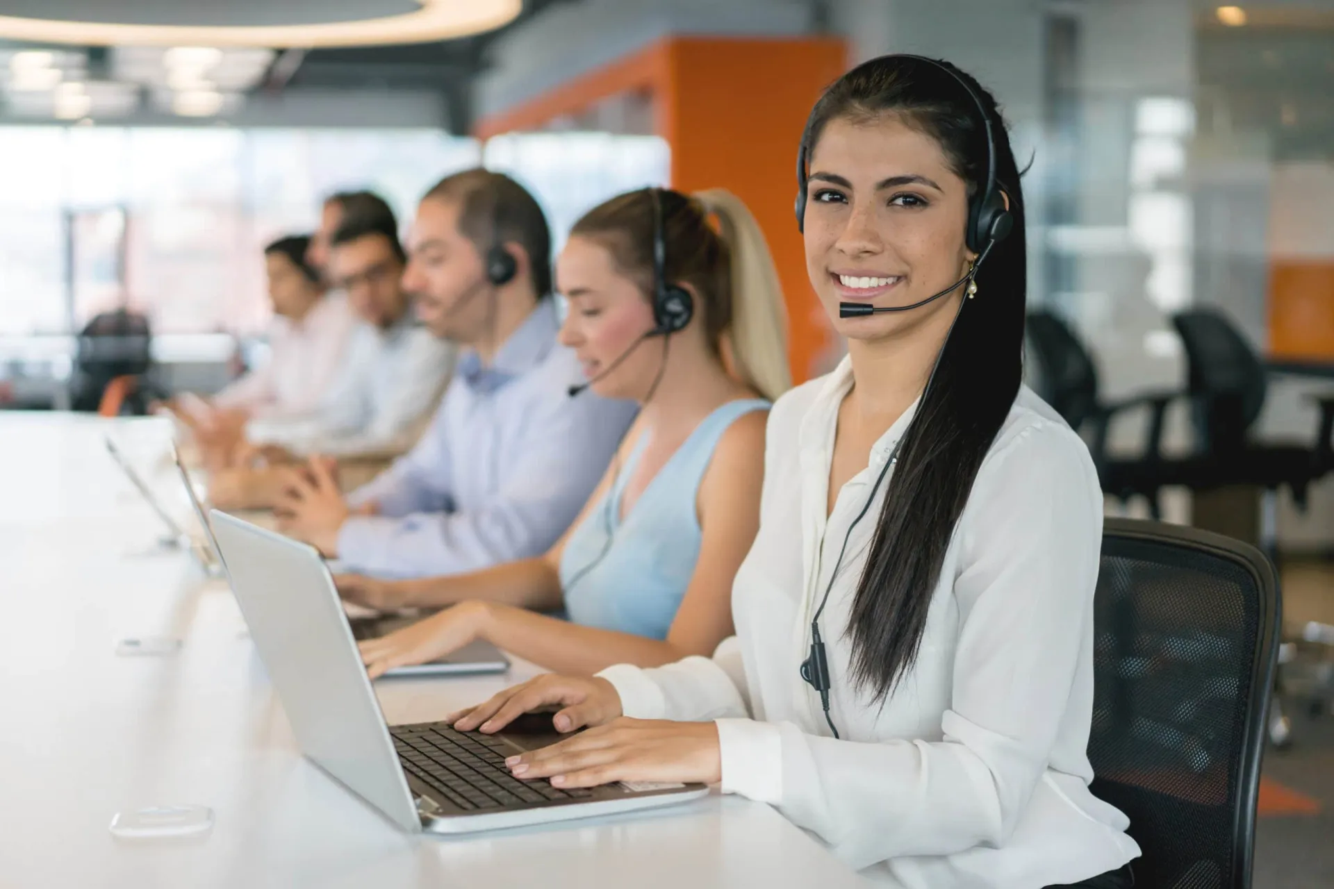 Customer Support Team at Work Customer support team with headsets working at a call center.