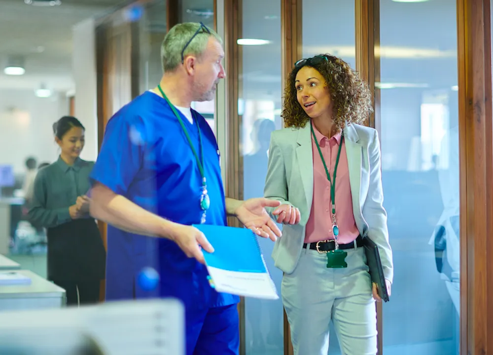 Healthcare sales team engaging with a medical professional in a hospital setting. Healthcare sales call communication and relationship building.