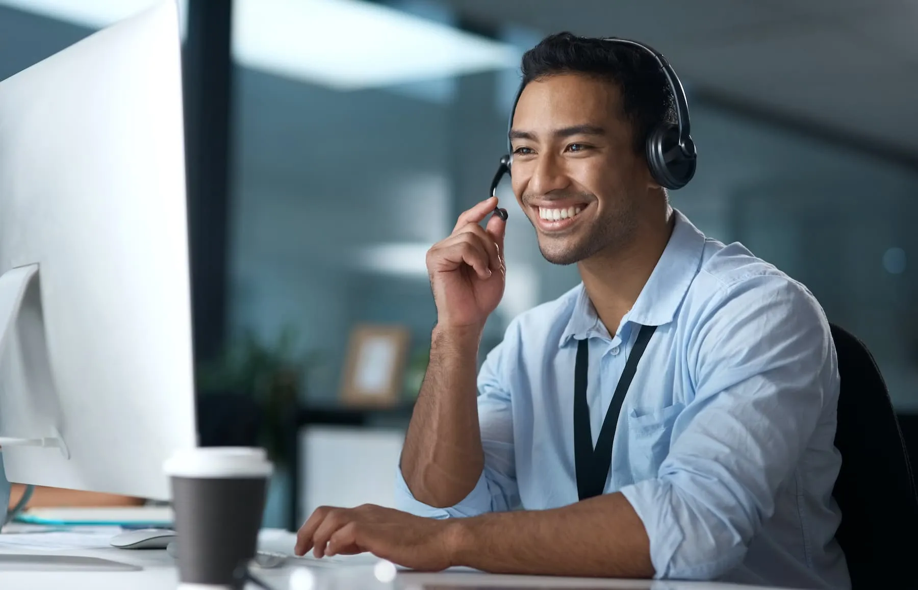 Use conversation (not clicks) to advance the sales cycle Customer service representative engaging with a client via headset in an office setting.