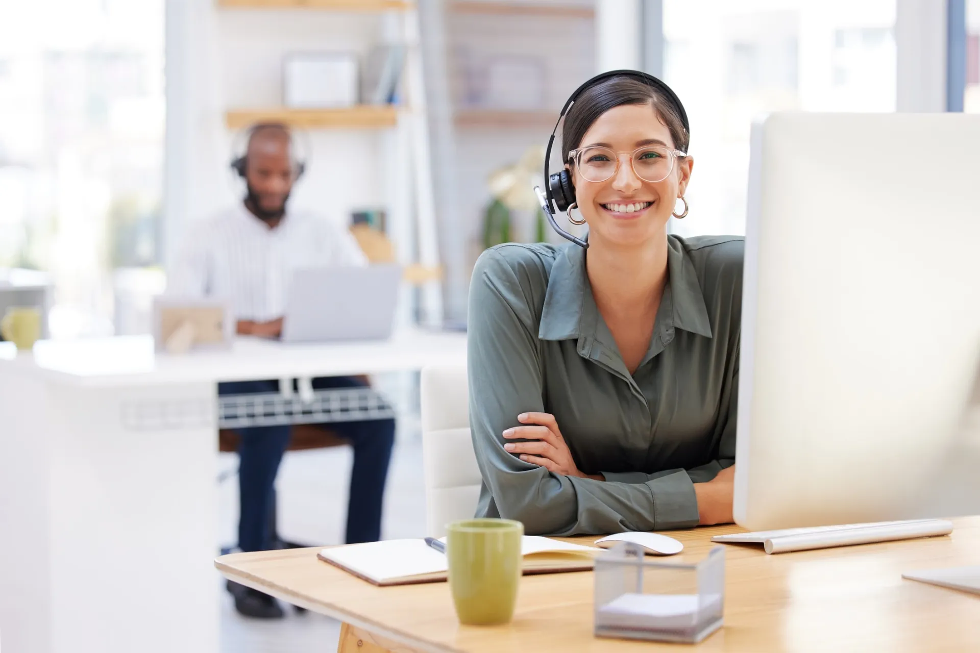 Customer Support Representative with Headset in Office Environment Customer support agent wearing a headset at her desk in a modern office setting.