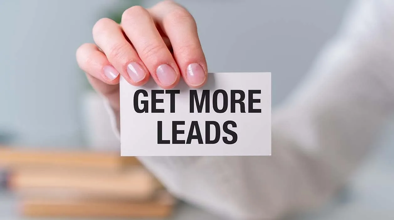 Get More Leads A person is holding a card that says Get more leads