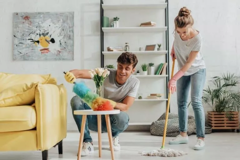 happy Couple cleaning a living room