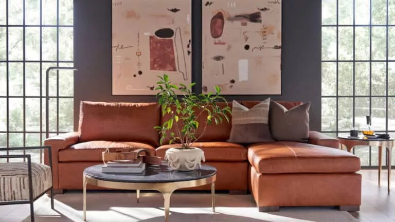 A decorated living room scene with a statement blood orange couch