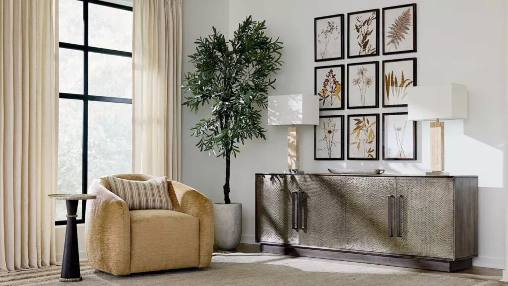 A scene of a decorative room with an arm chair and a side table